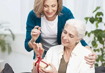 Daughter gifting home key to mother symbolizing dream home ownership in premium apartments